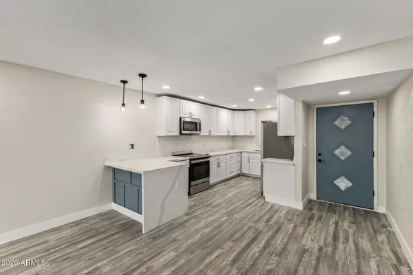 a large kitchen with stainless steel appliances granite countertop a large center island and a sink