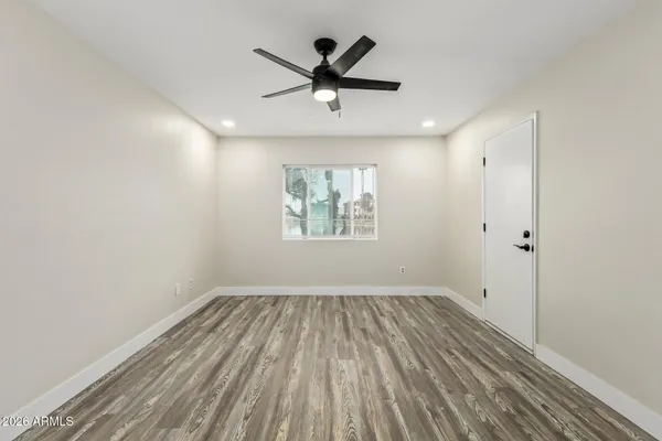 wooden floor in an empty room with a window