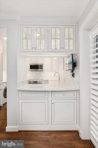 a kitchen with granite countertop white cabinets and a sink
