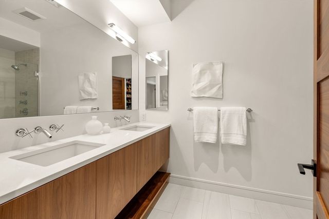 a bathroom with a double vanity sink mirror and