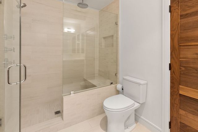 a bathroom with a toilet and shower