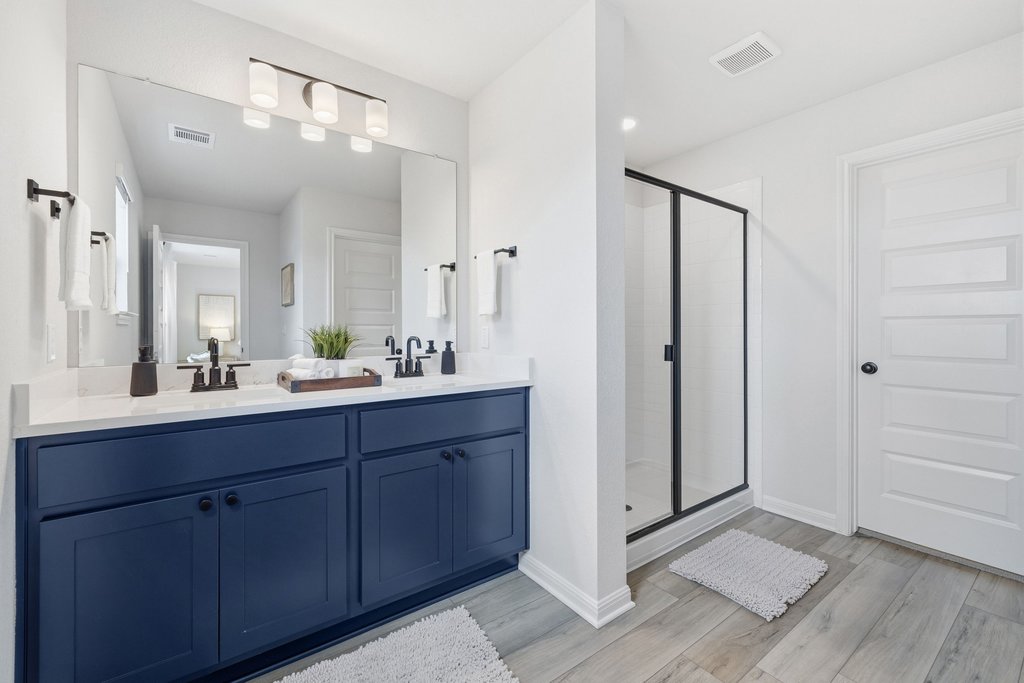 8001 Andravida Drive Austin, TX 78747 - Photo 22 of 35 Stylish primary bath with dual vanity and glass-enclosed shower