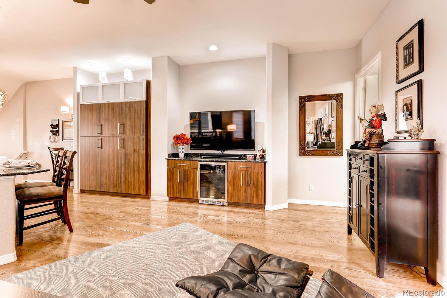 244 South Monroe Street Denver, CO 80209 - Photo 12 of 35 a kitchen with stainless steel appliances kitchen island granite countertop a refrigerator and a stove top oven