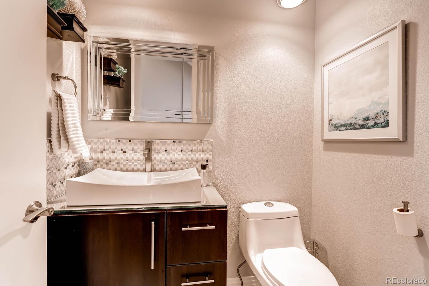 244 South Monroe Street Denver, CO 80209 - Photo 14 of 35 a bathroom with a sink and a toilet