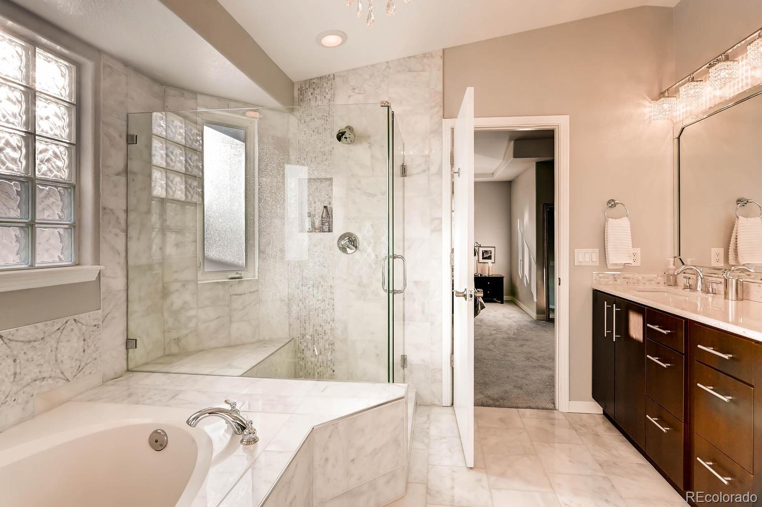 244 South Monroe Street Denver, CO 80209 - Photo 20 of 35 a bathroom with a tub sink shower and mirror