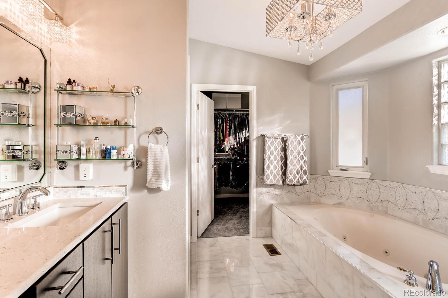 244 South Monroe Street Denver, CO 80209 - Photo 21 of 35 a bathroom with a tub sink and mirror