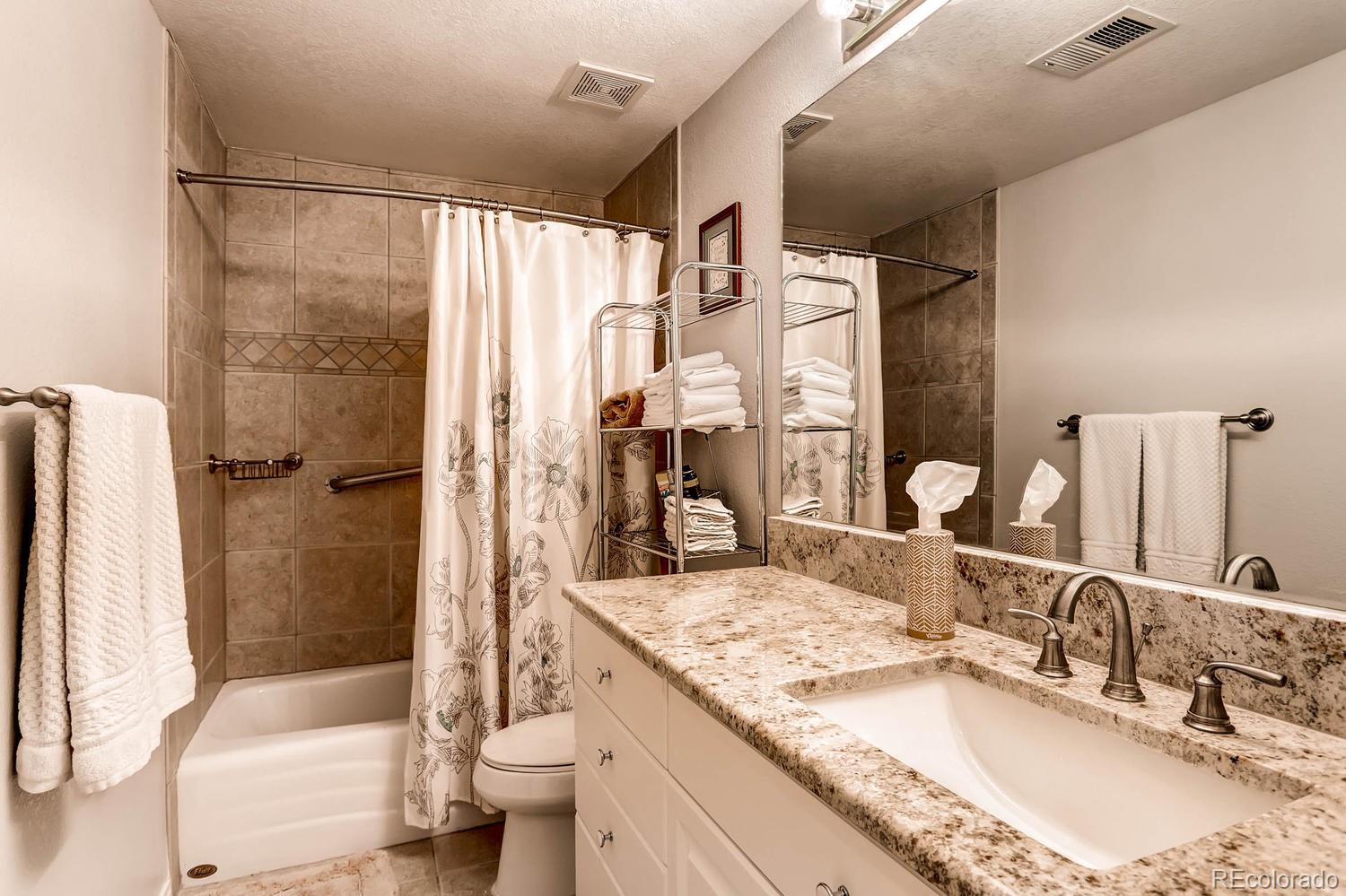 244 South Monroe Street Denver, CO 80209 - Photo 27 of 35 a bathroom with a granite countertop sink toilet and shower