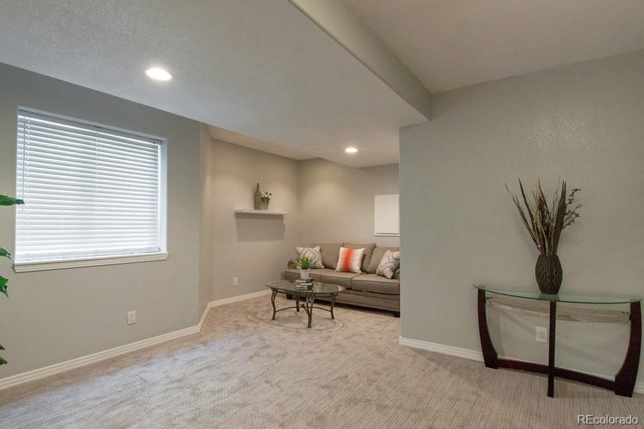 244 South Monroe Street Denver, CO 80209 - Photo 30 of 35 a living room with furniture and a window