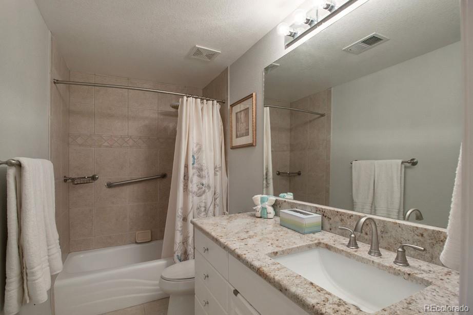 244 South Monroe Street Denver, CO 80209 - Photo 31 of 35 a bathroom with a granite countertop bathtub shower sink vanity and toilet
