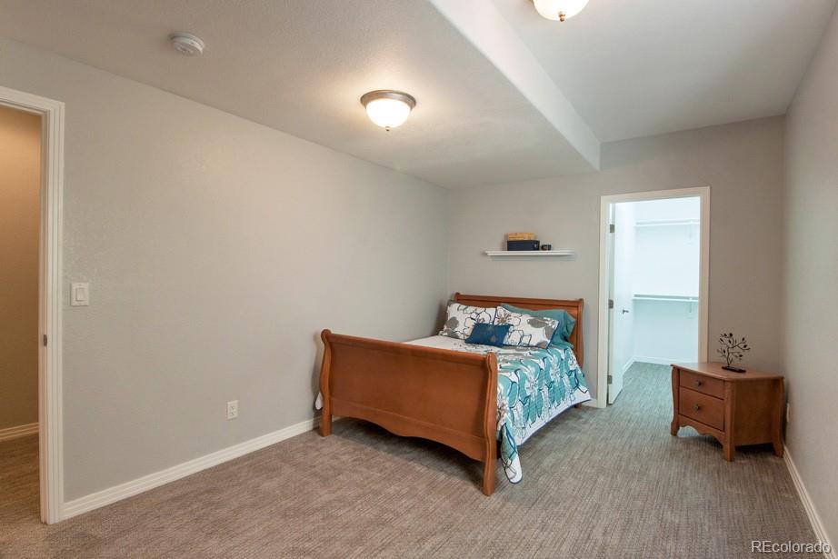 244 South Monroe Street Denver, CO 80209 - Photo 32 of 35 a bed room with a bed and a couch