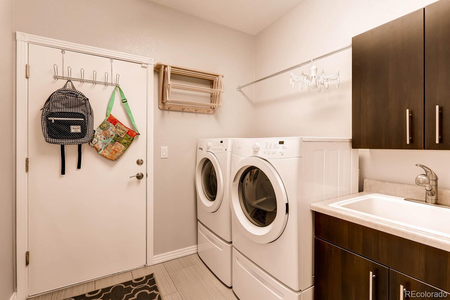 244 South Monroe Street Denver, CO 80209 - Photo 33 of 35 a utility room with dryer and washer