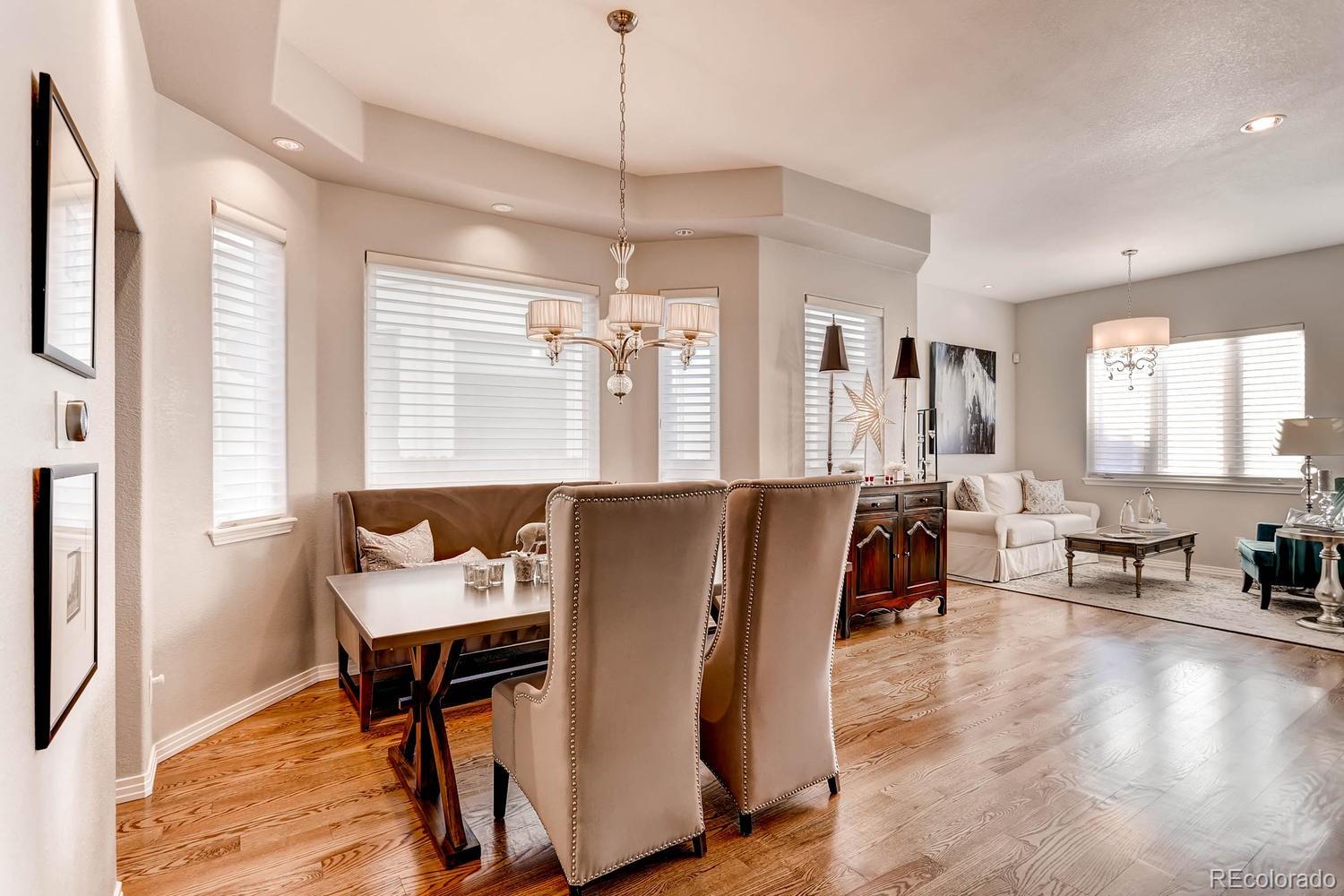 244 South Monroe Street Denver, CO 80209 - Photo 5 of 35 a living room with furniture a window and a chandelier