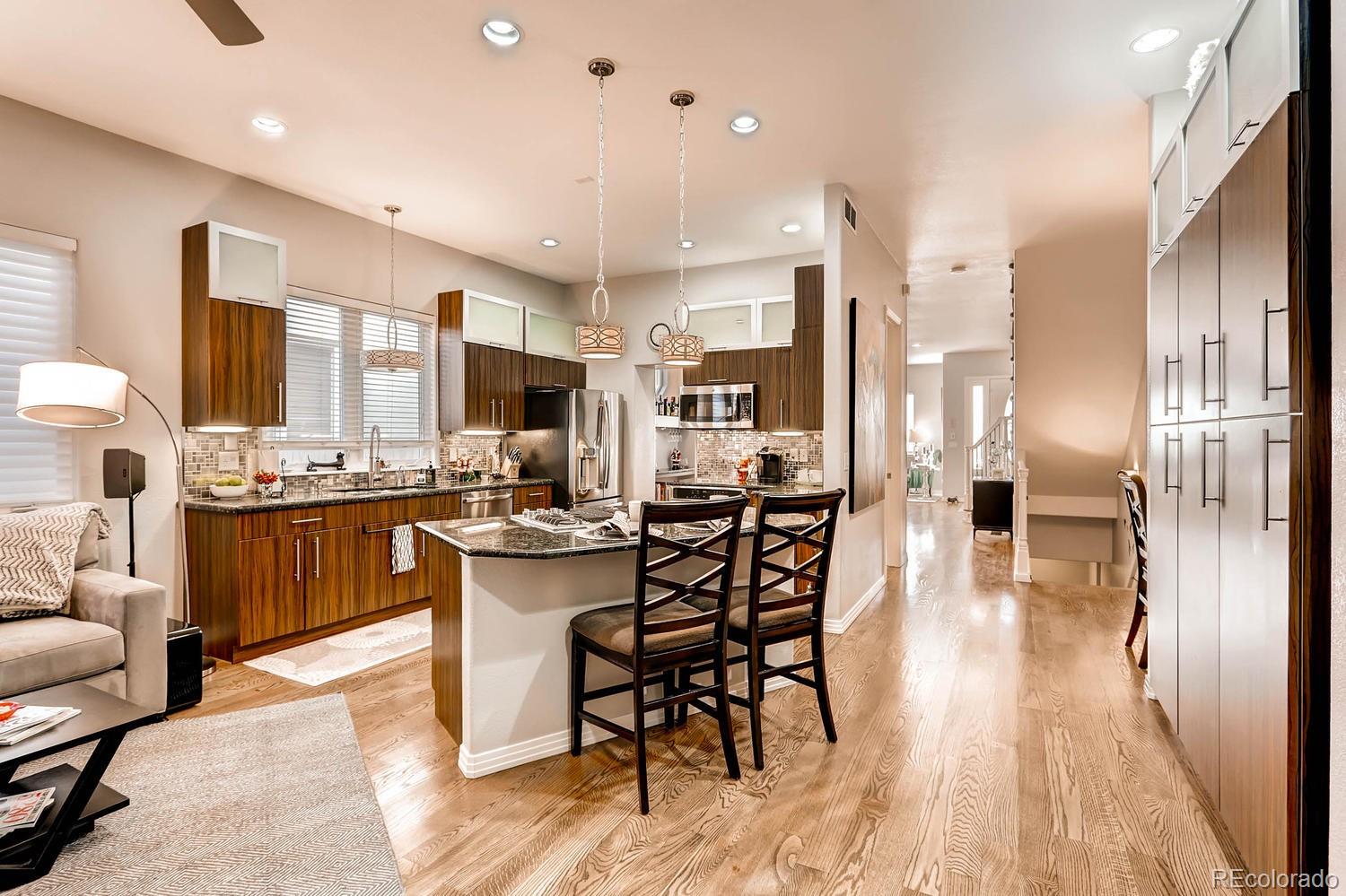 244 South Monroe Street Denver, CO 80209 - Photo 6 of 35 a kitchen with stainless steel appliances kitchen island granite countertop lots of counter top space and furniture