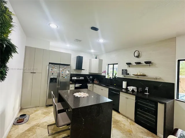 a kitchen with refrigerator and cabinets