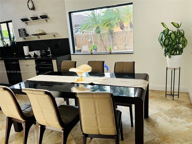 a dining room with furniture and window