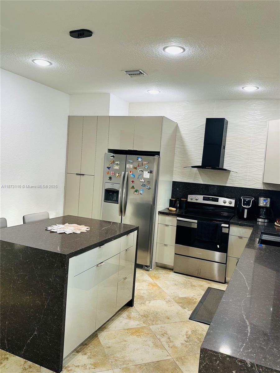 1608 Southwest 154th Court Miami, FL 33185 - Photo 16 of 22 a kitchen with kitchen island a sink appliances and a counter top space