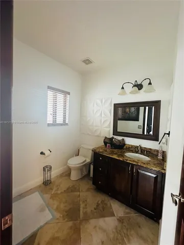 a living room with furniture a window and a flat screen tv