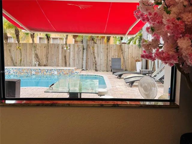 a view of a swimming pool with outdoor seating