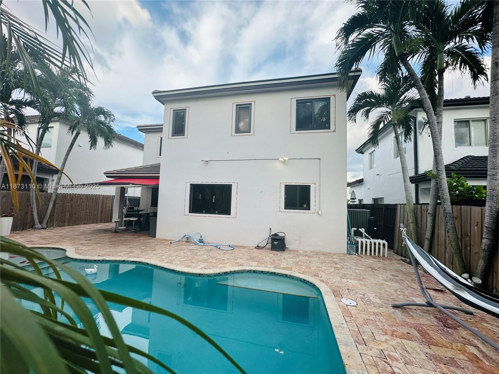 1608 Southwest 154th Court Miami, FL 33185 - Photo 20 of 22 a view of house with outdoor space and swimming pool