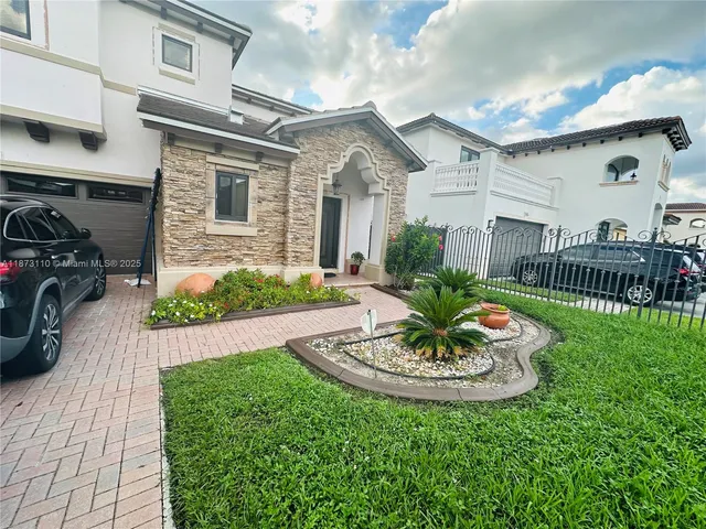 a view of a house with a table and chairs in patio