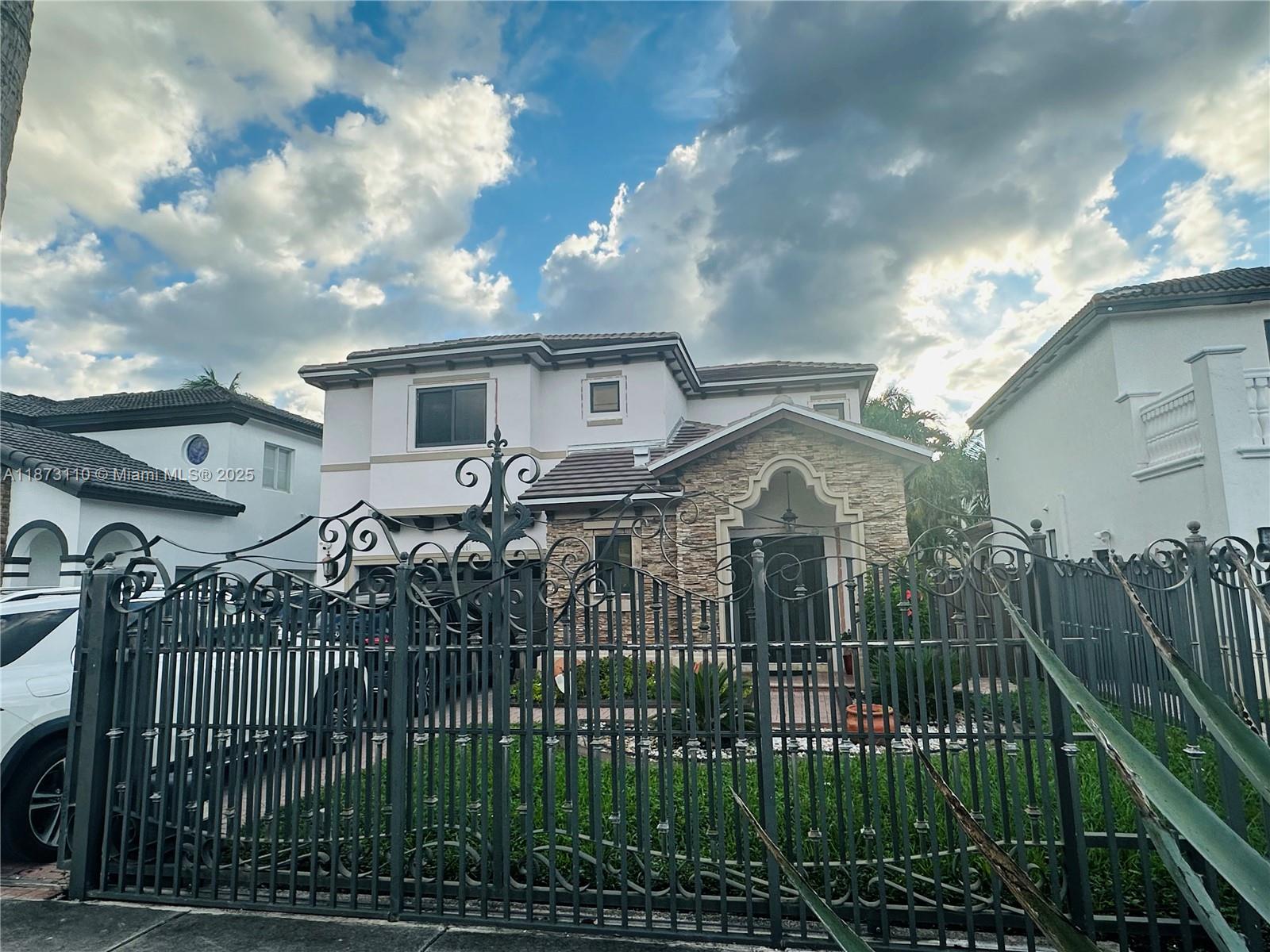 1608 Southwest 154th Court Miami, FL 33185 - Photo 22 of 22 a front view of a house with a garden