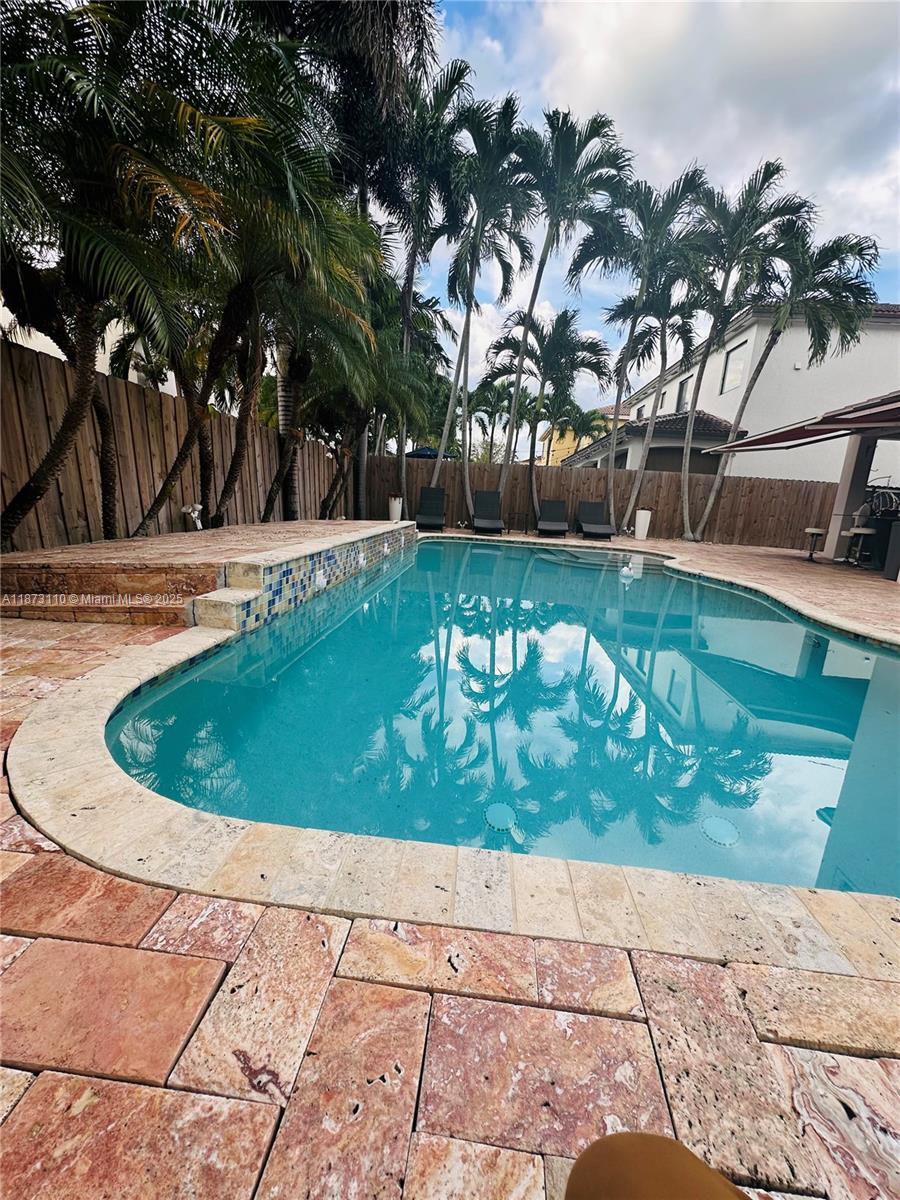 1608 Southwest 154th Court Miami, FL 33185 - Photo 3 of 22 a view of a swimming pool with a patio