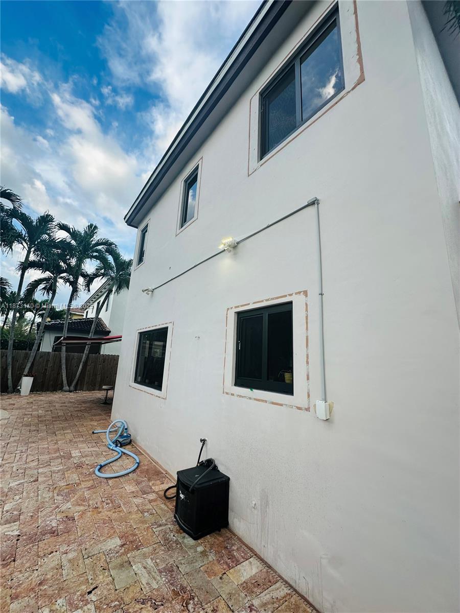 1608 Southwest 154th Court Miami, FL 33185 - Photo 5 of 22 a backyard of a house with seating space