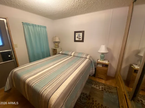 a bedroom with a bed and a mirror