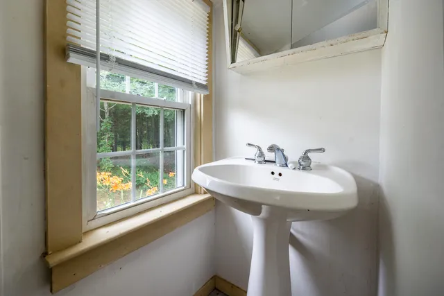 a bathroom with a sink and a window
