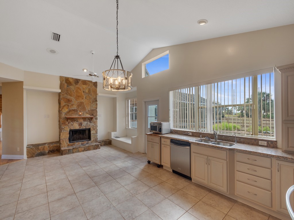 167 Deer Run Road Palm Bay, FL 32909 - Photo 14 of 35 a large kitchen with a large window appliances and cabinets