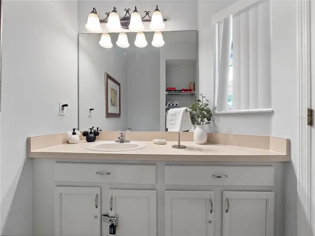 a bathroom with a sink vanity and a mirror