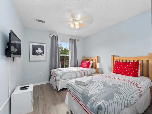 a bedroom with a bed and a chandelier