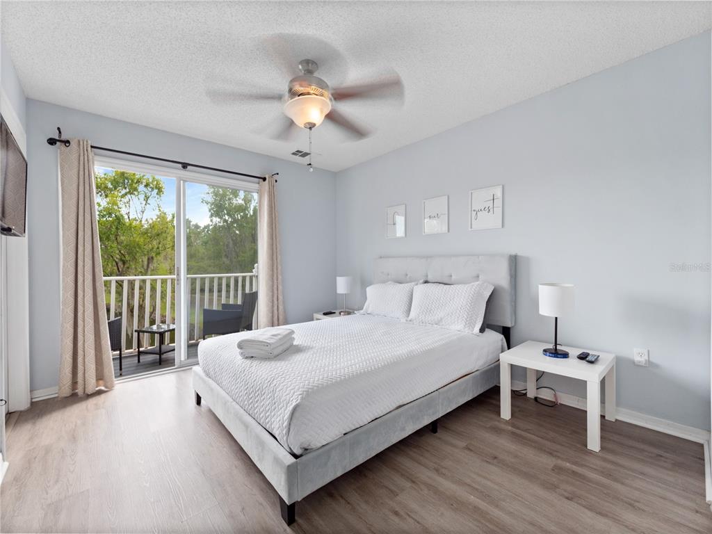 8517 Crystal Cove Loop Kissimmee, FL 34747 - Photo 16 of 20 a large white bed sitting in a bedroom next to a window