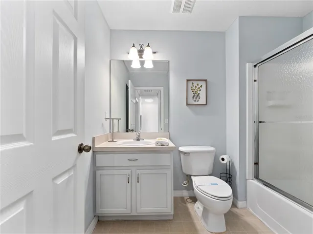a view of bathroom with a toilet sink and mirror