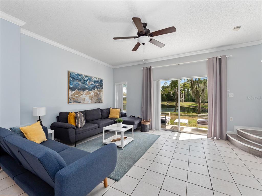 8517 Crystal Cove Loop Kissimmee, FL 34747 - Photo 5 of 20 a living room with furniture and a large window