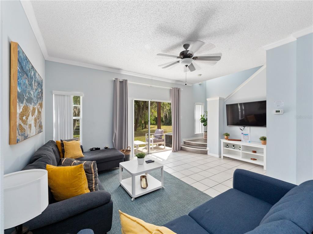 8517 Crystal Cove Loop Kissimmee, FL 34747 - Photo 7 of 20 a living room with furniture fireplace and a flat screen tv