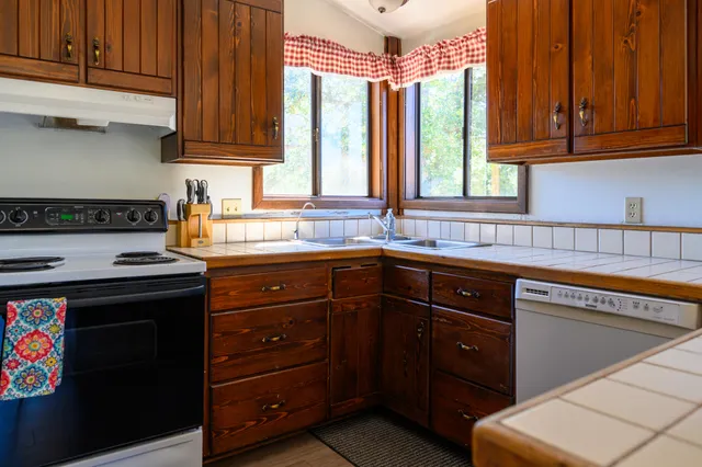 a kitchen with granite countertop a stove and a sink