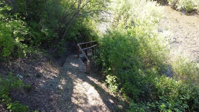 a bedroom with a bed and flat tv screen on dresser