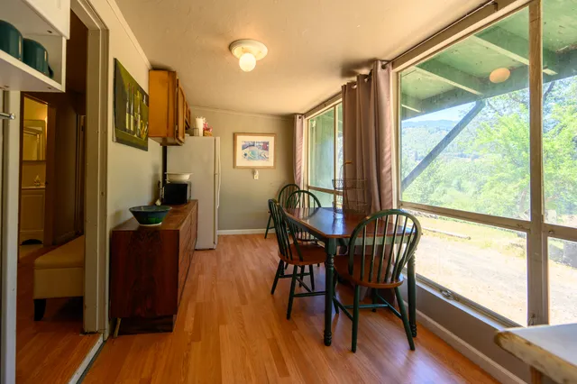a view of a dining room with furniture window and wooden floor
