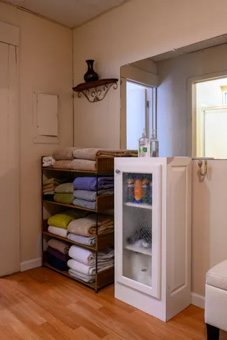 a living room with furniture and a baby crib