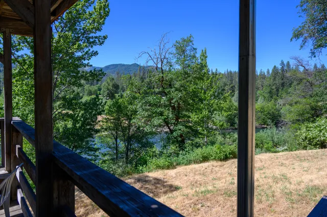 a view of a balcony with chairs and a potted plant
