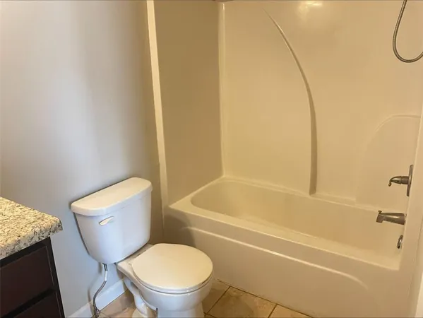 a bathroom with a toilet and a bath tub