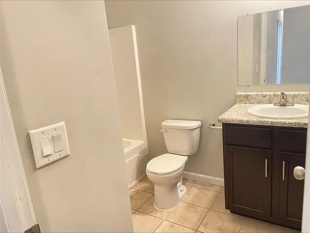 a white toilet sitting next to a bathroom sink