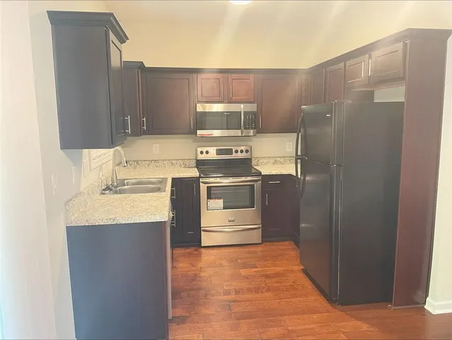 a kitchen with stainless steel appliances a refrigerator stove and sink