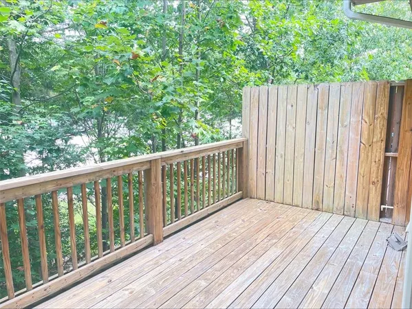a balcony with wooden floor and fence