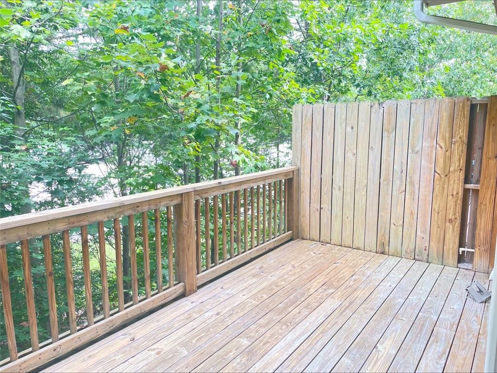 Undisclosed Address Norcross, GA 30093 - Photo 5 of 18 a balcony with wooden floor and fence