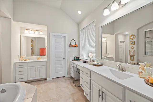 a spacious bathroom with a double vanity sink mirror and double