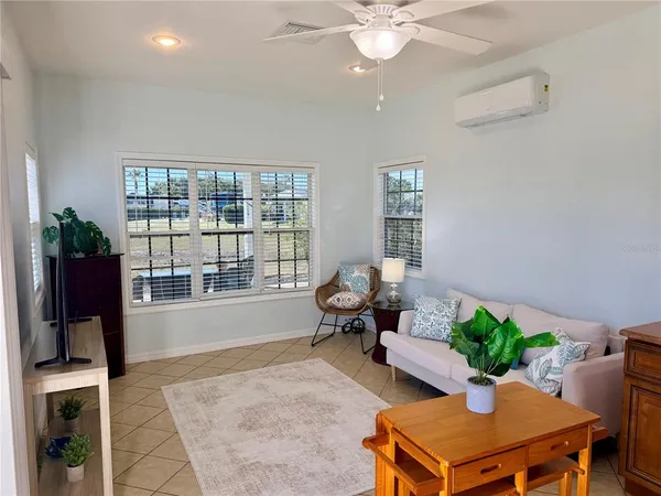 a living room with furniture and a potted plant