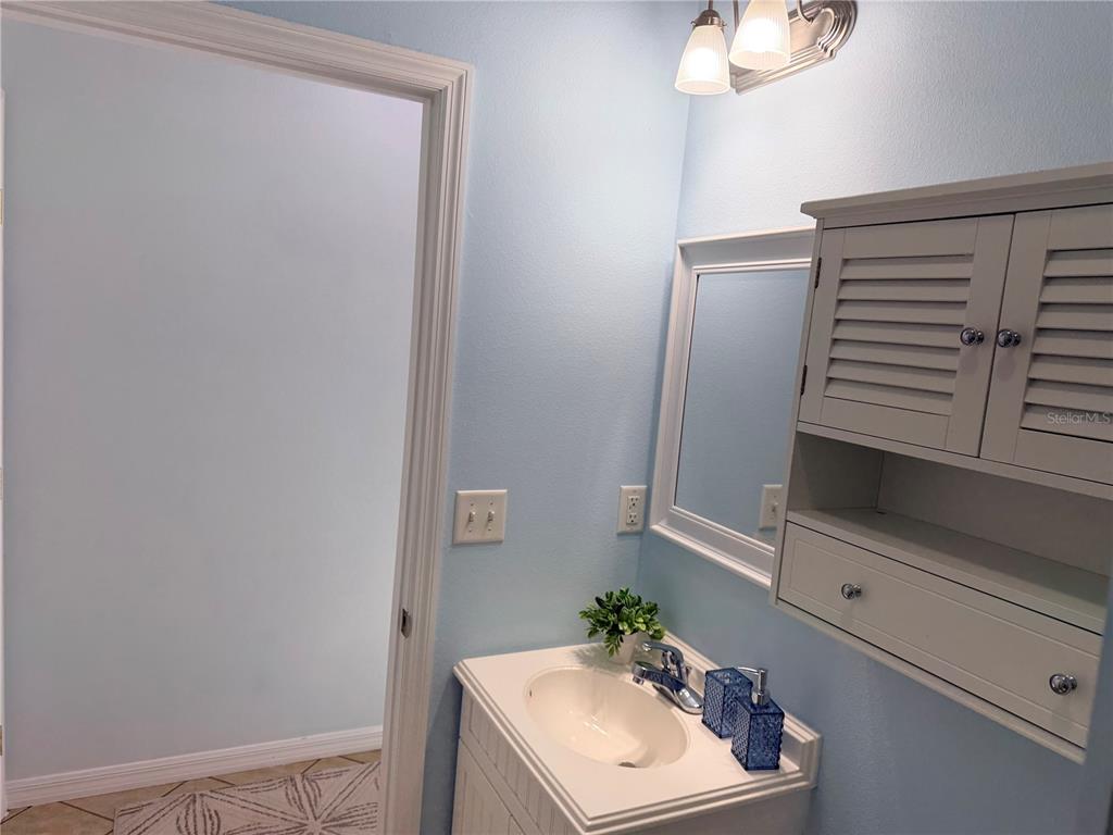 9404 Southeast 49th Terrace Webster, FL 33597 - Photo 24 of 42 a bathroom with a sink and a mirror
