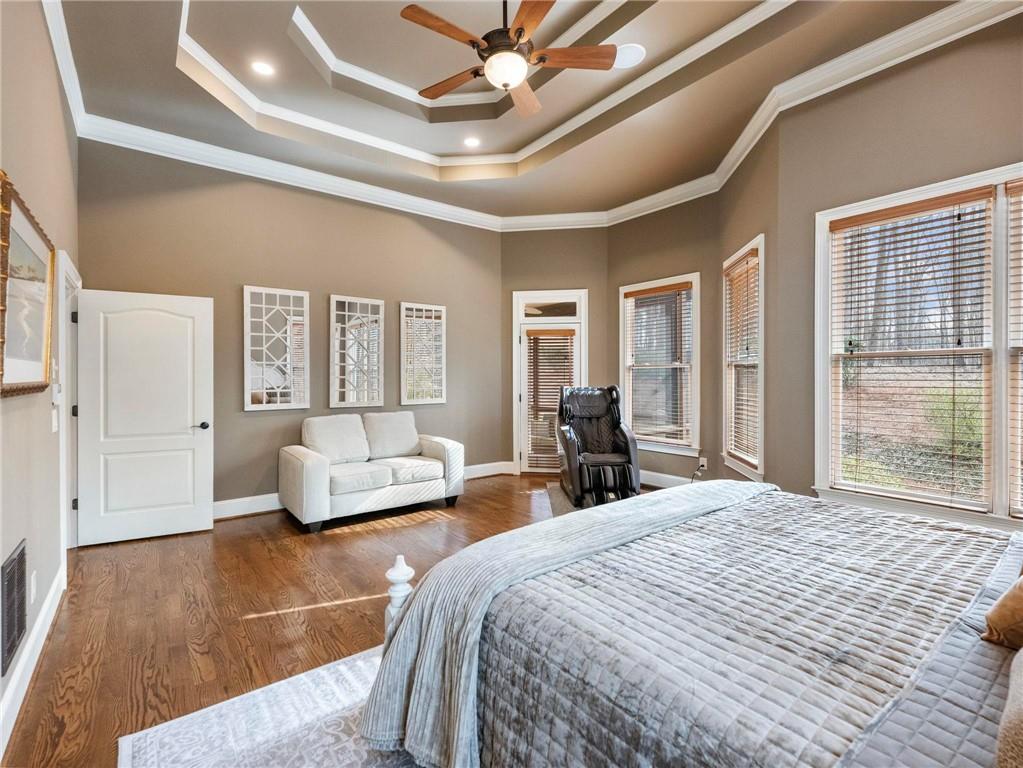 6147 Golf View Court Jefferson, GA 30549 - Photo 23 of 73 a spacious bedroom with a bed a couch and a large window